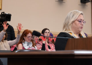 Code Pink protesters sitting behind Simone Ledeen, former Deputy Assistant Secretary of Defense for the Middle East. (Mathew Schumer / Capital News Service)