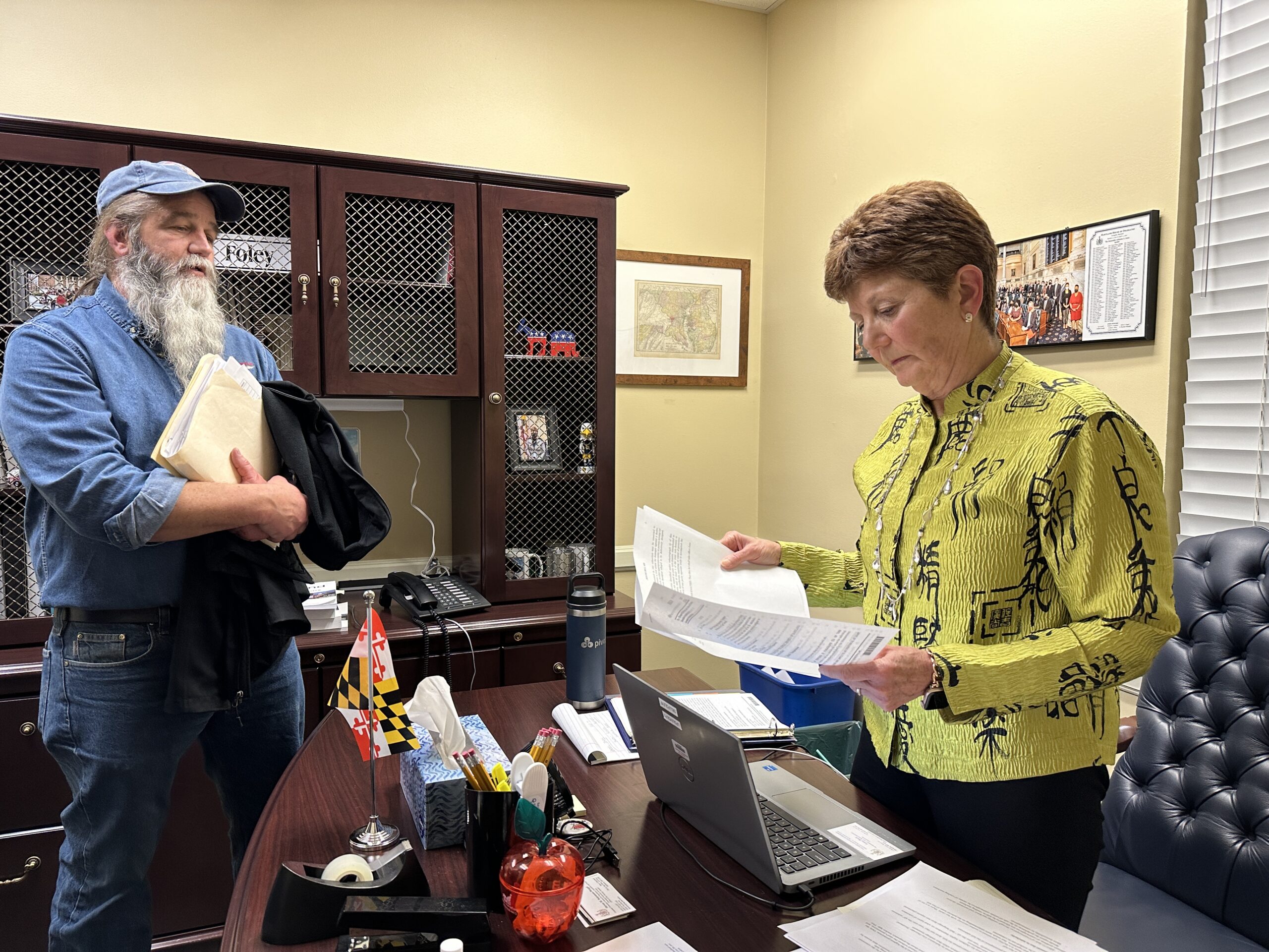 Ken Eaton, left, executive director of the motorcyclists' rights group A Brotherhood Against Totalitarian Enactments, provides information to Del. Linda Foley, D-Montgomery County, on Feb. 12, 2024 related to a bill that would gut Maryland’s mandatory helmet law. (Sapna Bansil/Capital News Service)