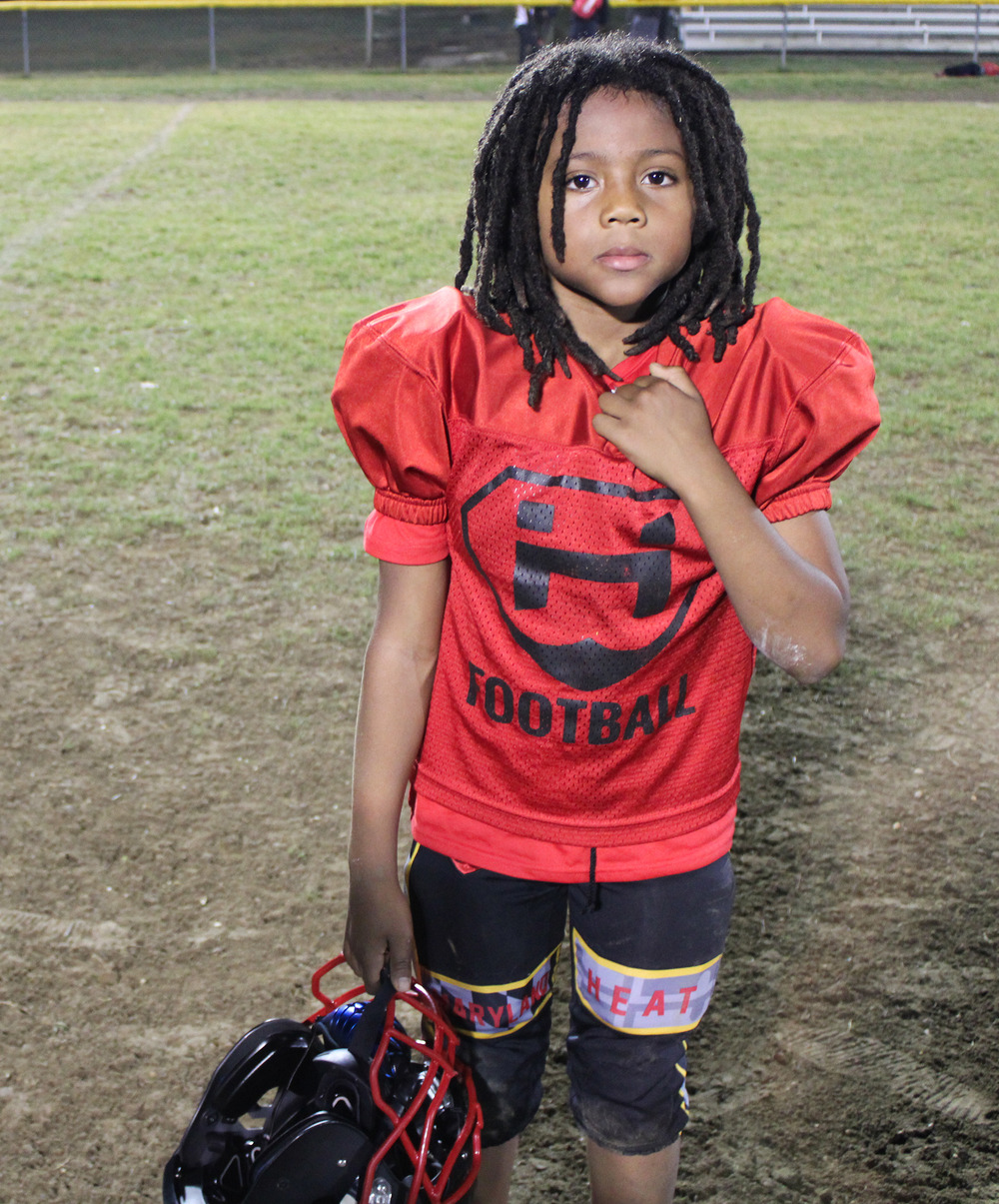Maryland Heat running back Santana Campfield, 9, takes a breather after practice in Fort Washington, Maryland, on Nov. 9, 2023. Photo by Torrence Banks/University of Maryland