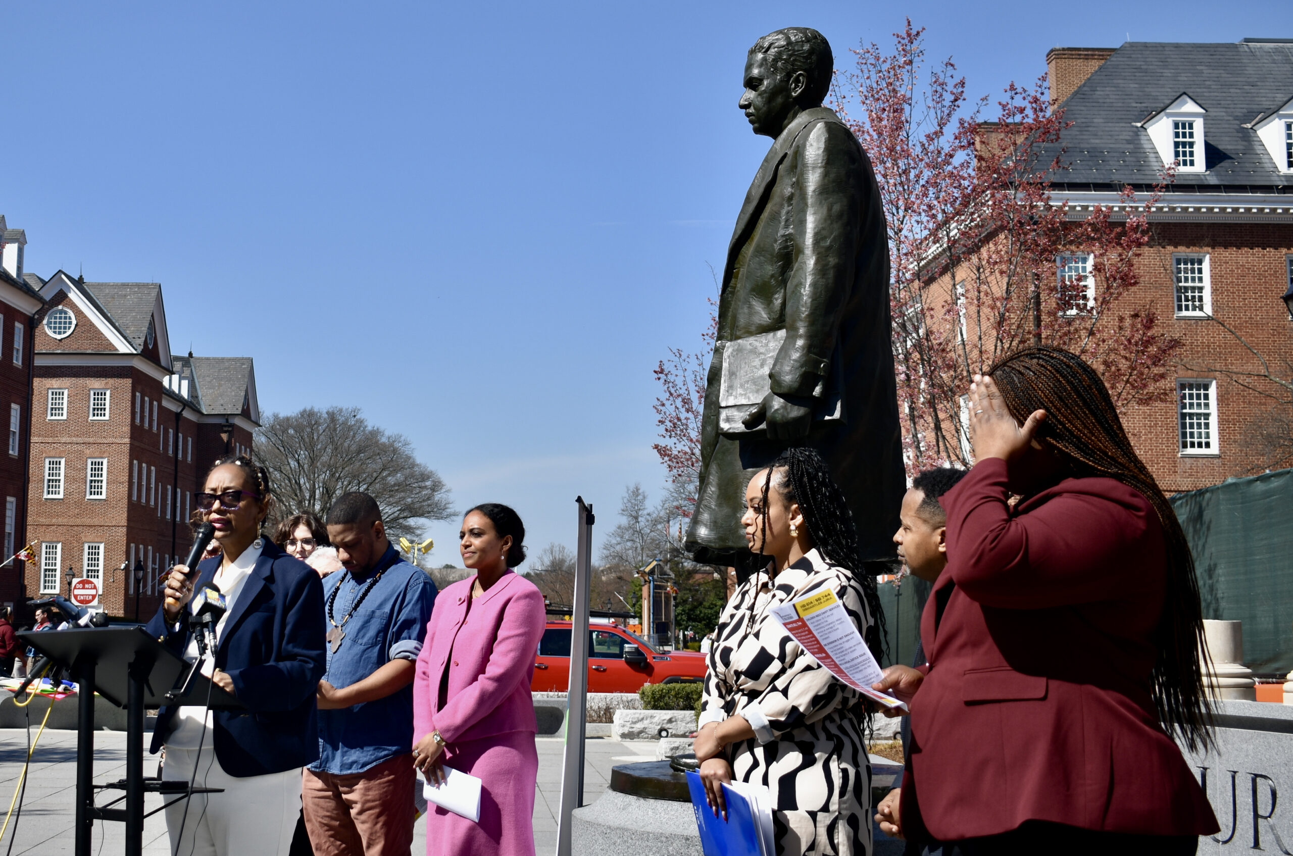 Social justice advocates gather on Lawyers Mall for a press conference. (Tyrah Burris/Capital News Service)