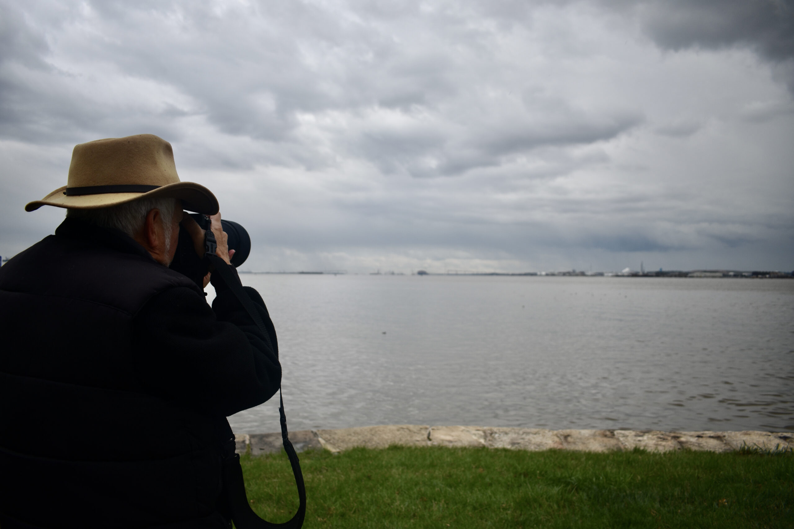 Jerry Lazarus taking a picture of the fallen bridge at Fort McHenry National Monument. (Tyrah Burris/Capital News Service)