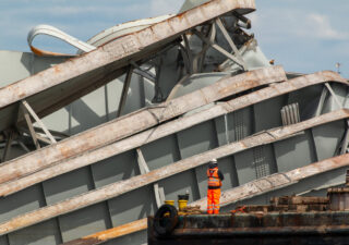 A salvage worker views wreckage of the Francisc Scott Key Bridge