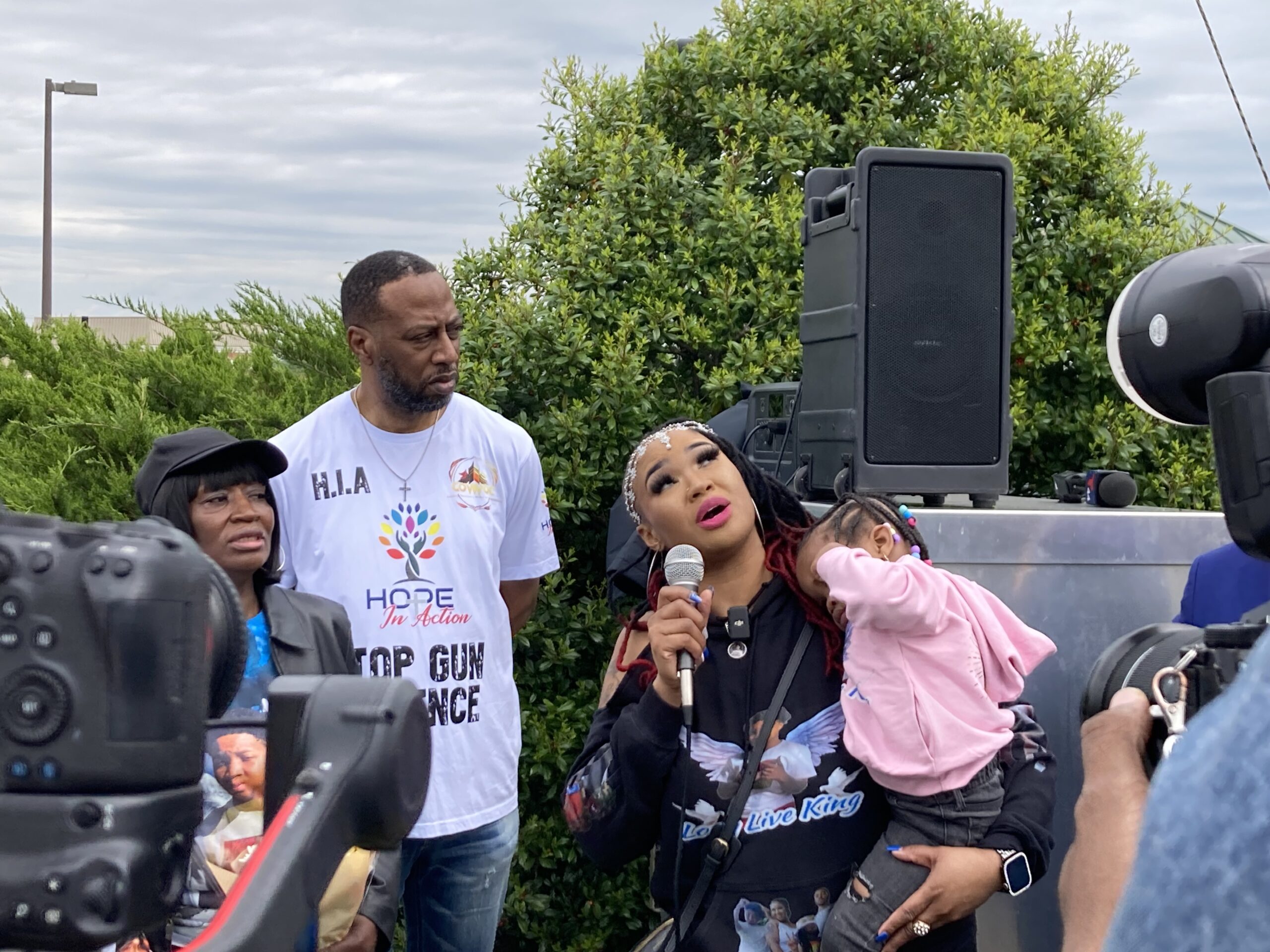 Ja'Ka McKnight looks up at a street sign naming her son, King Douglas, at a celebration of his life in Capitol Heights, Md., on April 20, 2024.