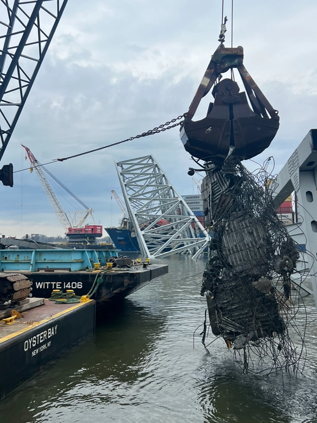 A crane lifts wreckage of the Francis Scott Key Bridge on April 10, 2024.