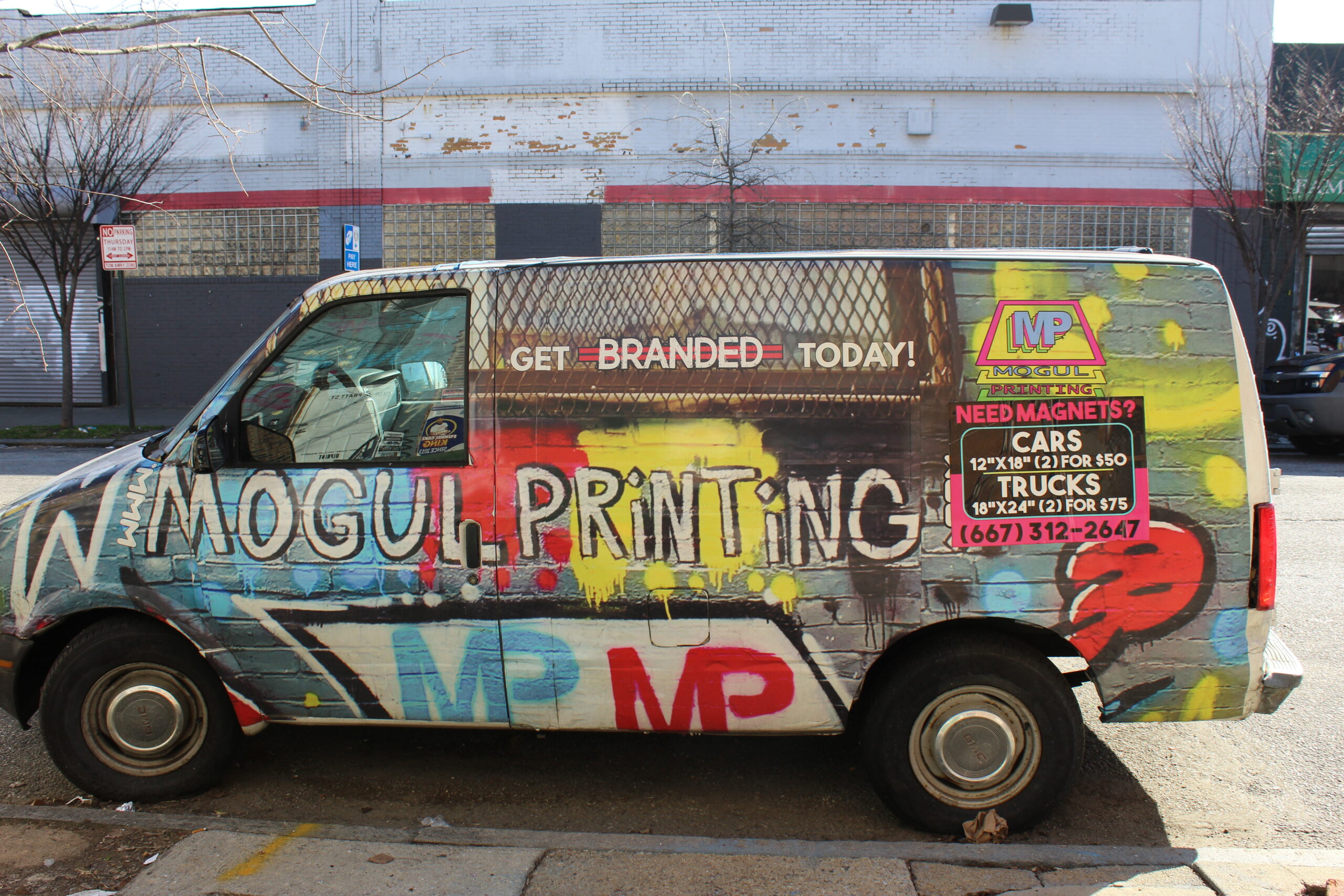 Van with graffiti and writing that says "Mogul Printing"