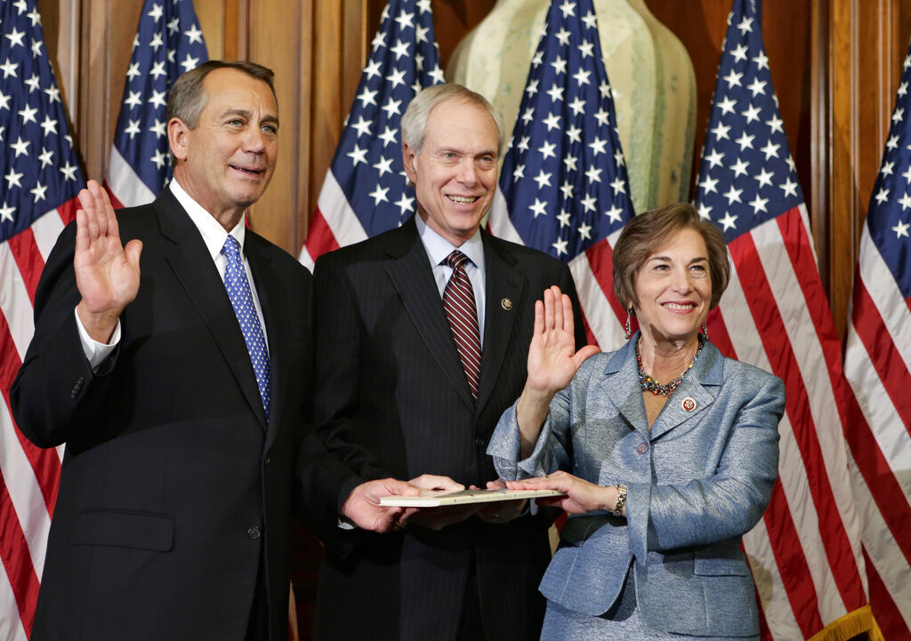 Rep. Jan Schakowsky, D-Ill., stands with her lobbyist husband, Richard Creamer, for a ceremonial photo with Speaker of the House John Boehner after her swearing in Jan. 3, 2013.