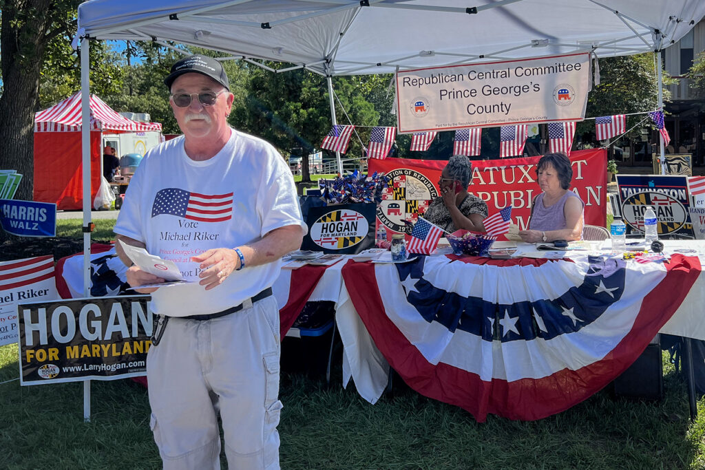 Republican candidate in front of canvasing booth