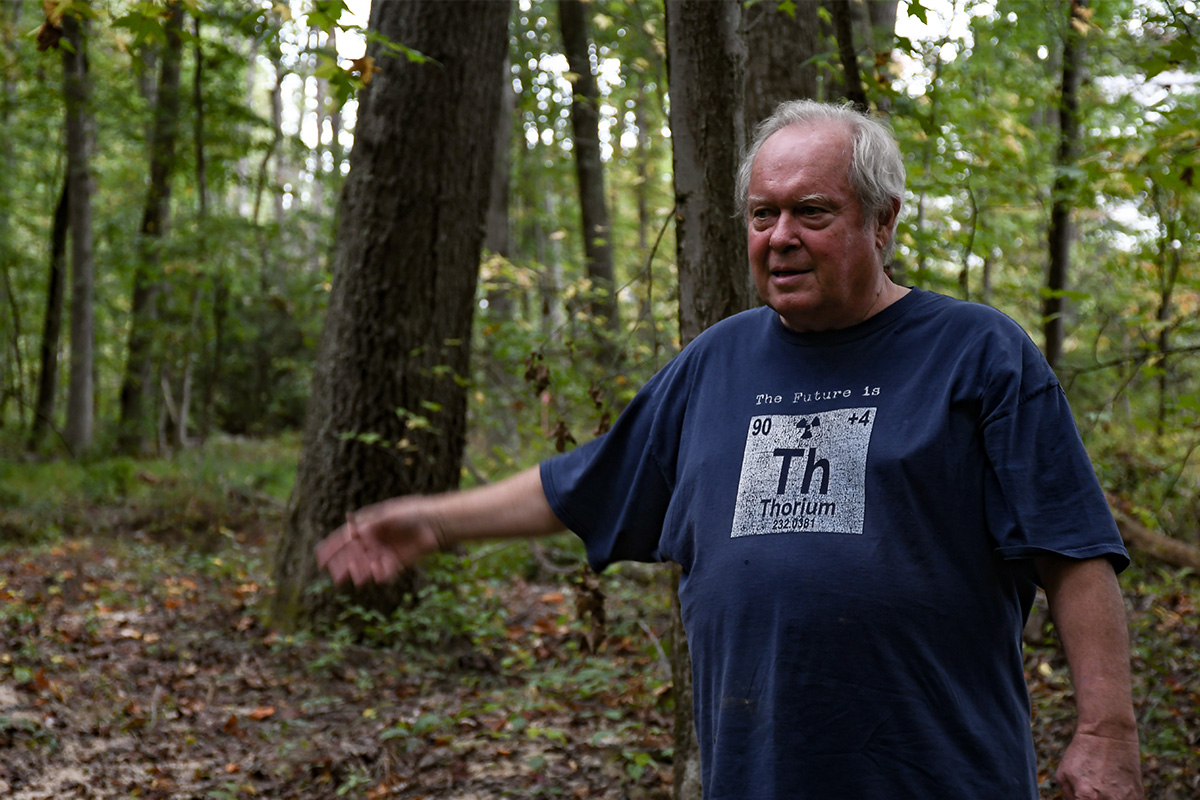 Bill Temmink points toward an area in the woods next to Ridgely’s Reserve, indicating where Foster Branch begins.