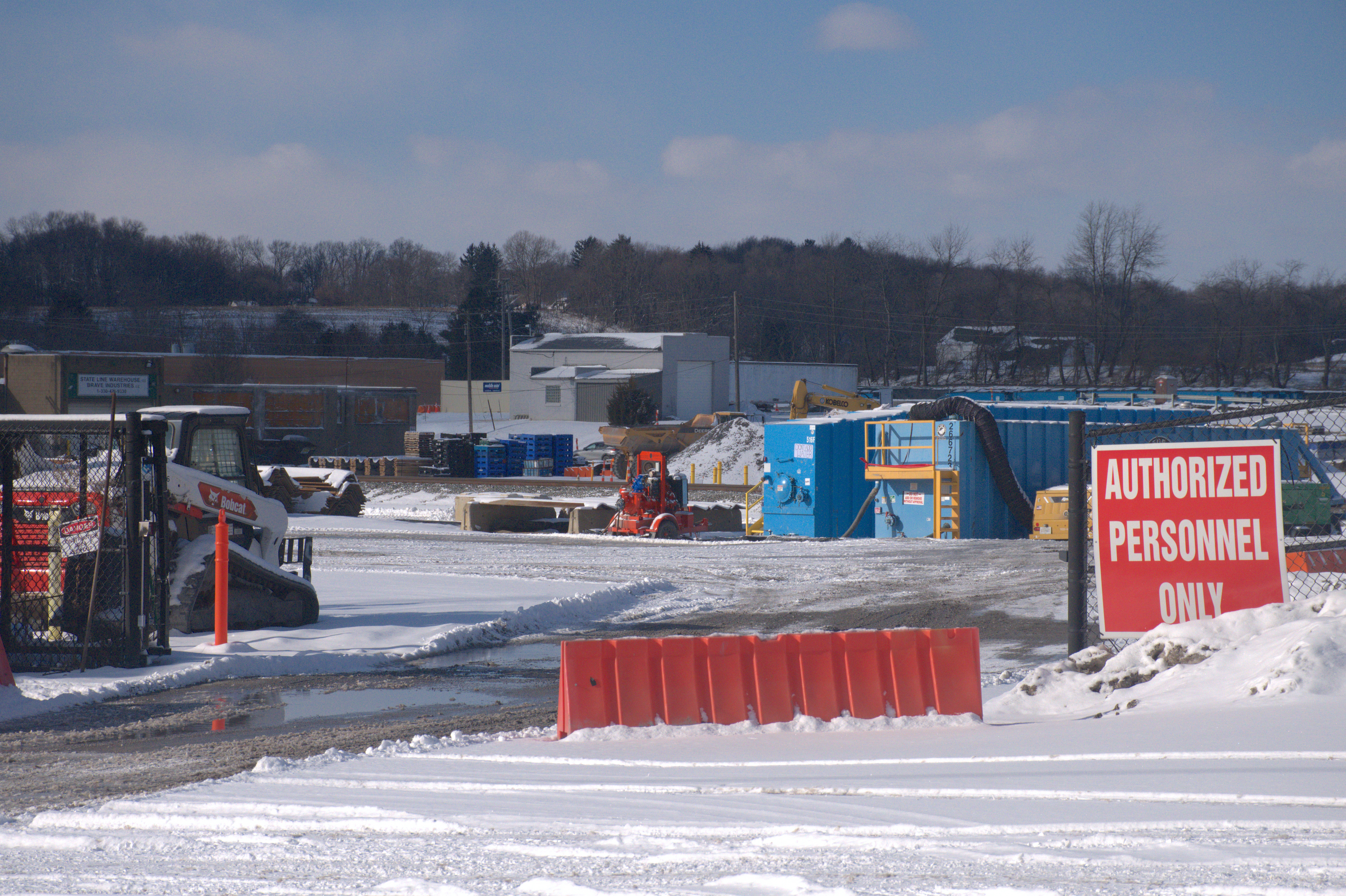 An “Authorized Personnel Only” sign at a construction site with train tracks in the backdrop. This is the derailment site of the Norfolk Southern train, about a mile from the village of East Palestine.