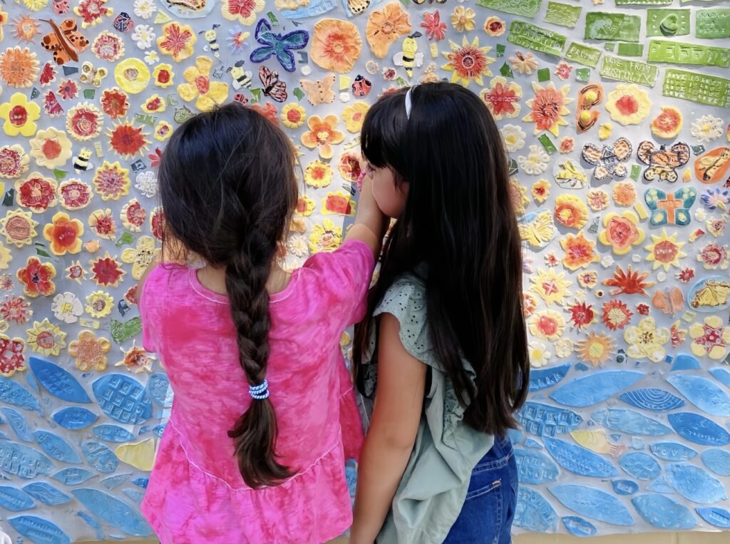 Children gaze at the mural at Uvalde Love Project. (Photo courtesy Uvalde Love Project)