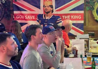 Bills fans dubbed quarterback Josh Allen their king on a flag gracing the wall of their NFL playoff watch party
