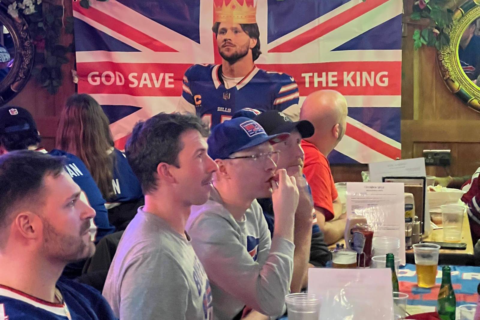 Bills fans dubbed quarterback Josh Allen their king on a flag gracing the wall of their NFL playoff watch party